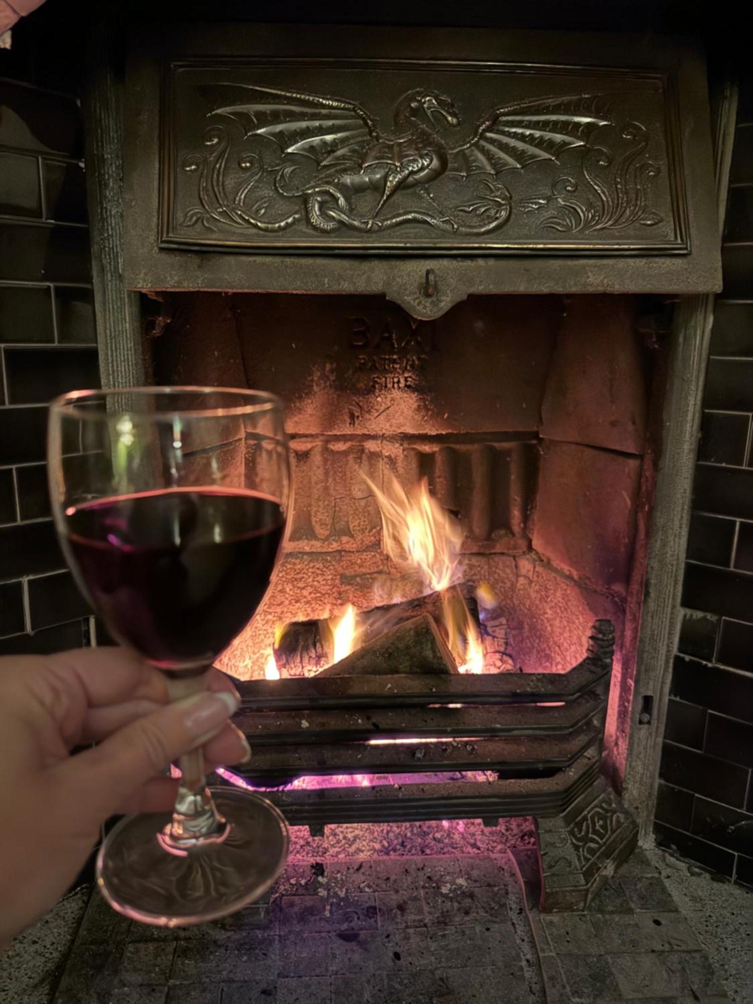 Clone Country House Aughrim Kültér fotó A glass of red wine in front of a fireplace
